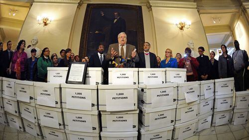 Deacon Richard Tolcher of the Catholic Archdiocese of Atlanta, center, helps deliver 26,000 letters to Gov. Nathan Deal signed by hundreds of Georgia faith leaders asking that Kelly Gissendaner be spared from execution. David Tulis/AJC Special