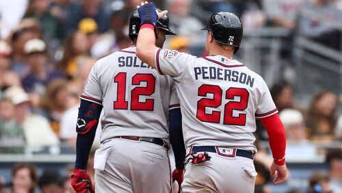 Braves' Joc Pederson (22) celebrates with Jorge Soler (12) after scoring on a double by Orlando Arcia against the San Diego Padres in the sixth inning Sunday, Sept. 26, 2021, in San Diego. (Derrick Tuskan/AP)