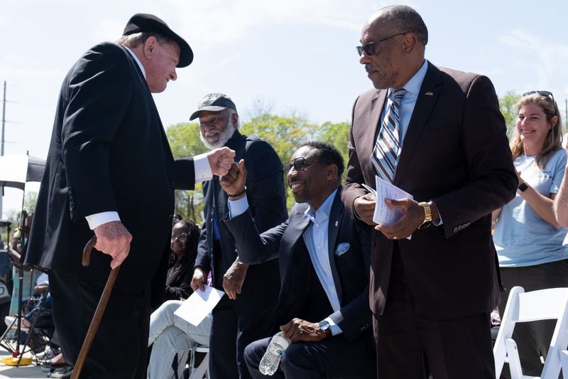 Clyde Strickland fist-bumps Atlanta Mayor Andre Dickens after speaking at the unveiling ceremony for a statue of the Rev. Martin Luther King Jr. in Rodney Cook Sr. Peace Park in Atlanta on Saturday, April 1, 2023. (Ben Gray / Ben@BenGray.com)
