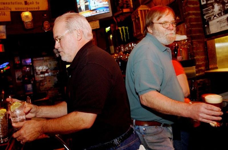 Bobby Agee (left) and Bill McCloskey serve customers at Manuel’s Tavern in 2005. McCloskey, a fixture at Manuel s for nearly 50 years, died Sunday, July 14, 2019. ELISSA EUBANKS / AJC file photo