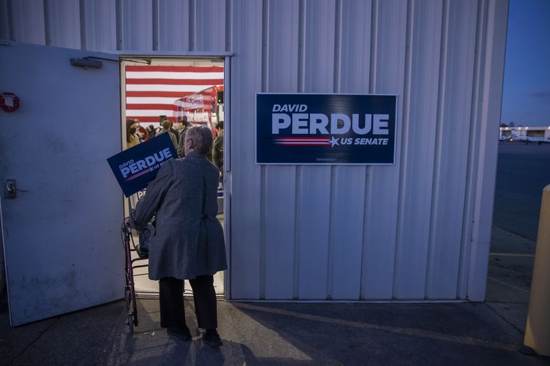Supporters arrive for David Perdue rally at DeKalb-Peachtree Airport during his reelection campaign in December 2020. He lost that race to Democrat Jon Ossoff in a January 2021 runoff.