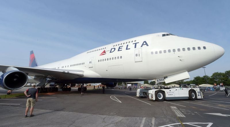 Crews move a retired Boeing 747-400 to the Delta Flight museum Saturday, April 30, 2016. Delta Air Lines Ship 6301 made its final journey to Delta’s Atlanta world headquarters campus in preparation for the Delta Flight Museum’s latest exhibit featuring the retired aircraft. On September 9, 2015, Delta retired Ship 6301, the first Boeing 747-400 aircraft manufactured for a commercial airline, after its final flight from Honolulu to Atlanta. KENT D. JOHNSON /kdjohnson@ajc.com