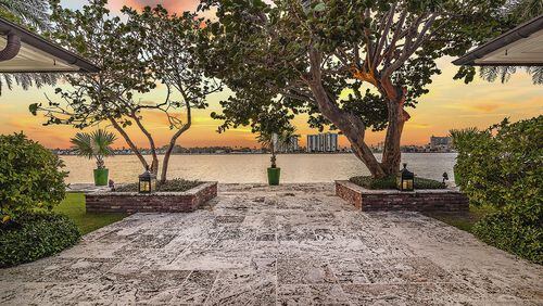 The loggia’s coral keystone floor continues to become a patio extending to the water’s edge. “We see beautiful sunsets and watch the boats,” Britty Damgard says. Photo by Giles Bradford, courtesy Tina Fanjul Associates/Brown Harris Stevens