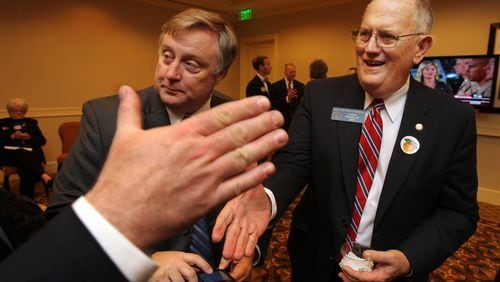 101102 Atlanta - Ralph Hudgens, right, Republican candidate for Commissioner of Insurance, shakes hands with supporters while watching returns come in at the Georgia Republican Party's election night event at the Grand Hyatt in Buckhead on Tuesday, Nov. 2, 2010. Curtis Compton ccompton@ajc.com Ralph Hudgens, right, the Republican state insurance commissioner, in a 2010 file photo. Curtis Compton ccompton@ajc.com
