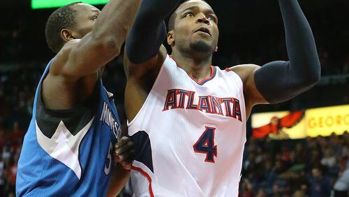 012515 ATLANTA: Hawks Paul Millsap gets past Timberwolves Gorgui Dieng for two of his team high 20-points during a basketball game on Sunday, Jan. 25, 2015, in Atlanta. Curtis Compton / ccompton@ajc.com