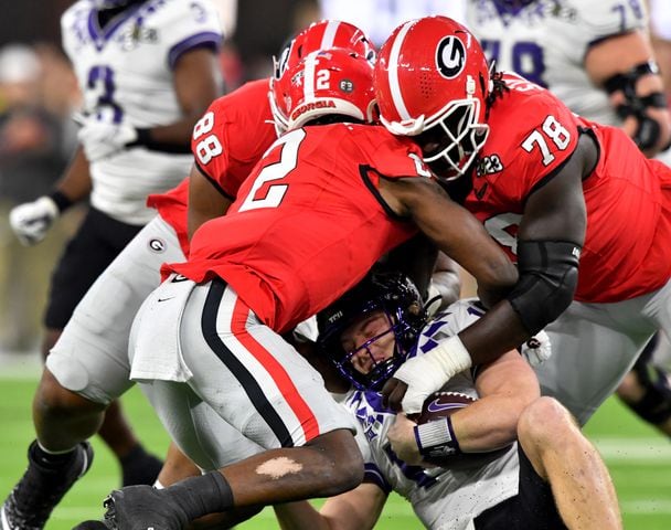 TCU Horned Frogs quarterback Max Duggan (15) is sacked by Georgia Bulldogs defenders during the first half of the College Football Playoff National Championship at SoFi Stadium in Los Angeles on Monday, January 9, 2023. (Hyosub Shin / Hyosub.Shin@ajc.com)
