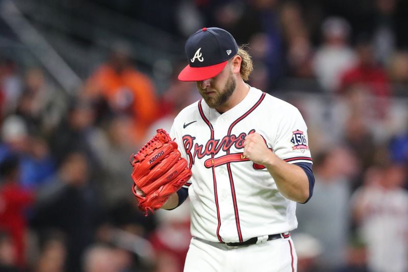 Braves relief pitcher A.J. Minter reacts to Los Angeles Dodgers center fielder Gavin Lux flying out to end the top of the fifth inning of Game 2 of the NLCS Sunday, Oct. 17, 2021, at Truist Park in Atlanta. (Curtis Compton / curtis.compton@ajc.com)