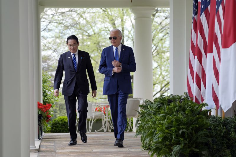 President Joe Biden and Japanese Prime Minister Fumio Kishida walk from the Oval Office to a news conference in the Rose Garden of the White House, Wednesday, April 10, 2024, in Washington. (AP Photo/Evan Vucci)