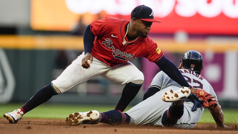 Cleveland Guardians first base Josh Naylor (22) steals seconnd base against Atlanta Braves' Ozzie Albies during the first inning of a baseball game, Friday, April 26, 2024, in Atlanta. (AP Photo/Mike Stewart)