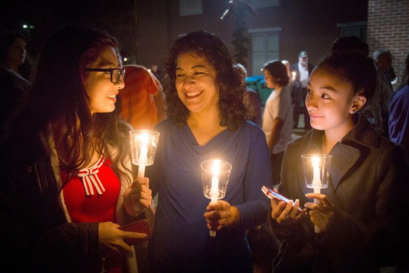 SNELLVILLE CHRISTMAS--Nathaly Mandujano, Flora Mandujano, and Emily Mandujano hold candles before the Tree Lighting during the 34th Annual Snellville Christmas Tree Lighting and Christmas Parade, Saturday in Snellville, Ga. STEVE SCHAEFER / SPECIAL TO THE AJC