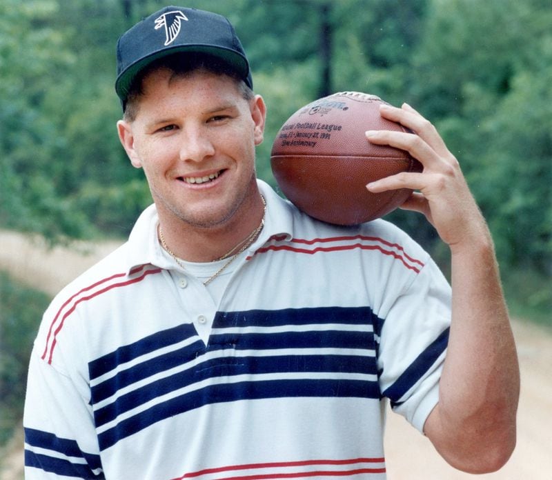 A decidedly younger Brett Favre poses in his new Falcons cap back home in Mississippi shortly after being drafted 33rd overall by the team in 1991. (AJC file photo)
