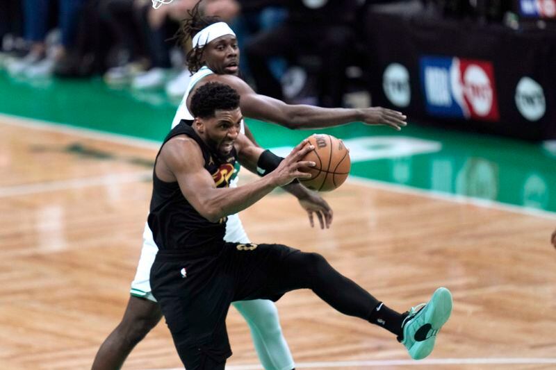Cleveland Cavaliers guard Donovan Mitchell, front, grabs a rebound next to Boston Celtics guard Jrue Holiday during the first half of Game 1 of an NBA basketball second-round playoff series Tuesday, May 7, 2024, in Boston. (AP Photo/Charles Krupa)