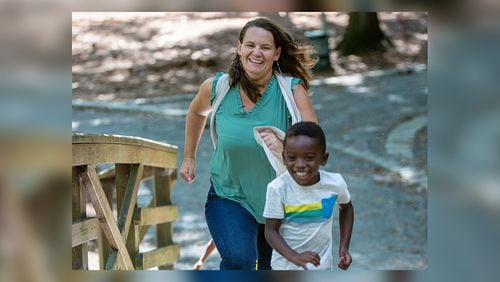 Single foster mom and adoptive mom, Amanda Vandalen, races Jeremiah, age 4, during an outing at Lake Avondale in Avondale Estates. She is also a social worker with the Gateway Center, a transitional shelter for the homeless on Prior Street in Atlanta. (Photo by Phil Skinner)