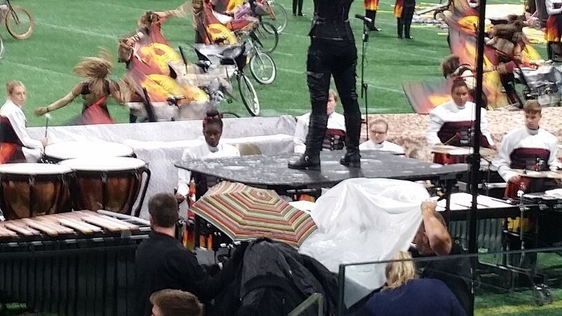 An umbrella provided cover from a roof leak at Mercedes-Benz Stadium on Saturday.