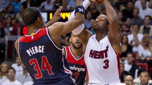 Miami Heat guard Dwyane Wade (3) looks to pass as he is defended by Washington Wizards forward Paul Pierce (34) at AmericanAirlines Arena in Miami, Florida on Oct. 29.. (Allen Eyestone / The Palm Beach Post)