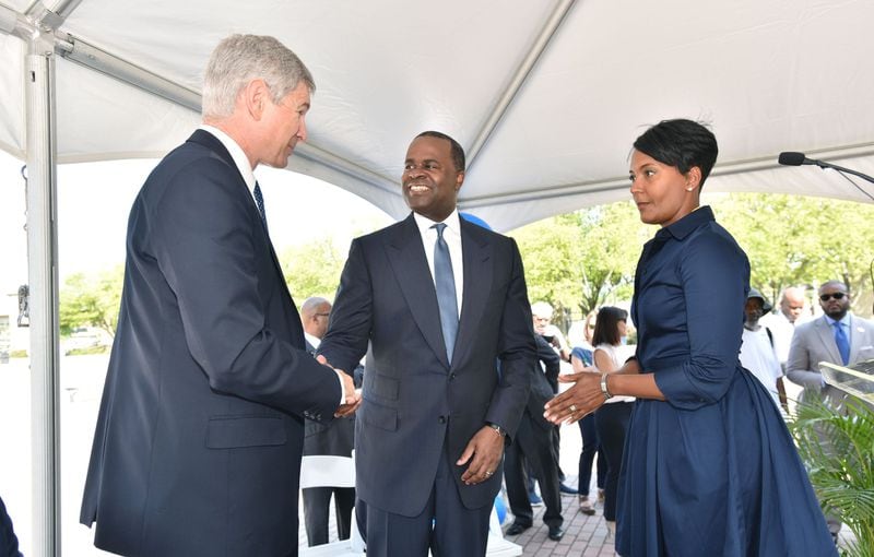 AUGUST 18, 2016 — Georgia State University President Mark Becker (left) and Atlanta Mayor Kasim Reed shake hands as Atlanta City Councilwoman Keisha Lance Bottoms (right) looks on following an announcement on Aug. 18, 2016, that a deal had been reached for Georgia State and its development partners to purchase Turner Field, the 20-year-old former Olympic stadium and former home of the Atlanta Braves. Councilwoman Bottoms is also director of the Atlanta Fulton County Recreation Authority. The Rec Authority and the Braves are fighting over money now that the team has left Atlanta for Cobb County. (Photo: Hyosub Shin/ hshin@ajc.com)