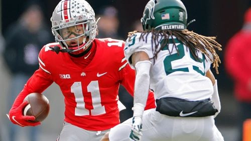 Ohio State wide receiver Jaxon Smith-Njigba (11) tries to get past Michigan State cornerback Marqui Lowery (29) after a catch in the second quarter at Ohio Stadium in Columbus, Ohio, on Saturday, Nov. 20, 2021. (Kyle Robertson/Columbus Dispatch/TNS)