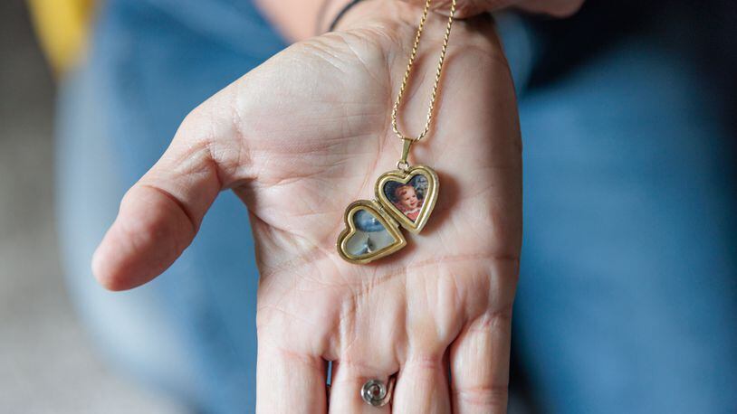 Michelle Cleveland displays a locket with a photo of her son Nicholas. Nicholas, and his brother Thomas, died by suicide in 2016. Read more about their story in the associated article. (Arvin Temkar / arvin.temkar@ajc.com)