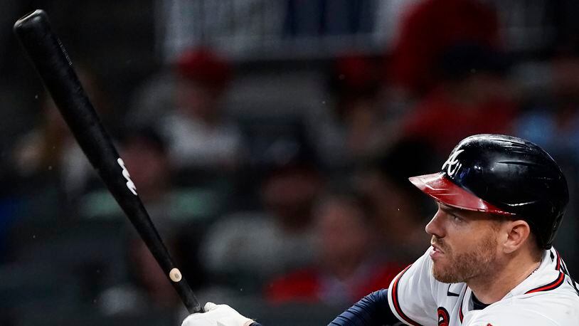 Atlanta Braves' Freddie Freeman (5) follows through on a double during the fifth inning of the team's baseball game against the New York Mets on Wednesday, June 30, 2021, in Atlanta. (AP Photo/John Bazemore)