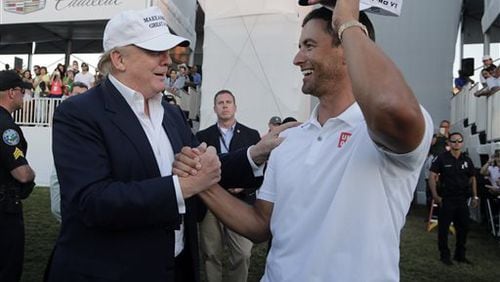 FILE - In this March 6, 2016, file photo, Republican presidential candidate Donald Trump, left, congratulates Adam Scott, right, after Scott won the Cadillac Championship golf tournament in Doral, Fla. Donald Trump is losing business to Mexico, a prestigious golf tournament at his resort at Doral. The tournament chairman of the former Cadillac Championship, one of the four World Golf Championships that attract the best players in the world, said the PGA Tour has informed him the event is leaving next year for Mexico City. (AP PhotoLynne Sladky, File0