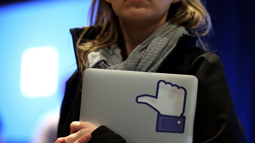 MENLO PARK, CA - APRIL 04: A Facebook employee holds a laptop with a 'like' sticker on it during an event at Facebook headquarters during an event at Facebook headquarters on April 4, 2013 in Menlo Park, California. (Photo by Justin Sullivan/Getty Images)
