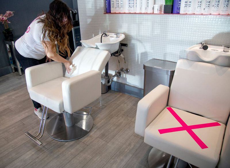 Blo Blow Dry Bar district manager Maria Dowling sanitizes the chair after washing a client’s hair at the Buckhead location Thursday, July 2, 2020. STEVE SCHAEFER FOR THE ATLANTA JOURNAL-CONSTITUTION
