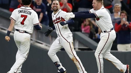 Ender Inciarte, center, celebrates his game-winning squeeze bunt against the Mets with Dansby Swanson and Freddie Freeman. (Mike Zarrilli/Getty Images)