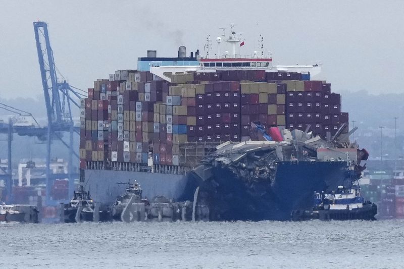 Crews work to move the cargo ship Dali in Baltimore, Monday, May 20, 2024. The vessel on March 26 struck the Francis Scott Key Bridge causing it to collapse and resulting in the death of six people. (AP Photo/Matt Rourke)