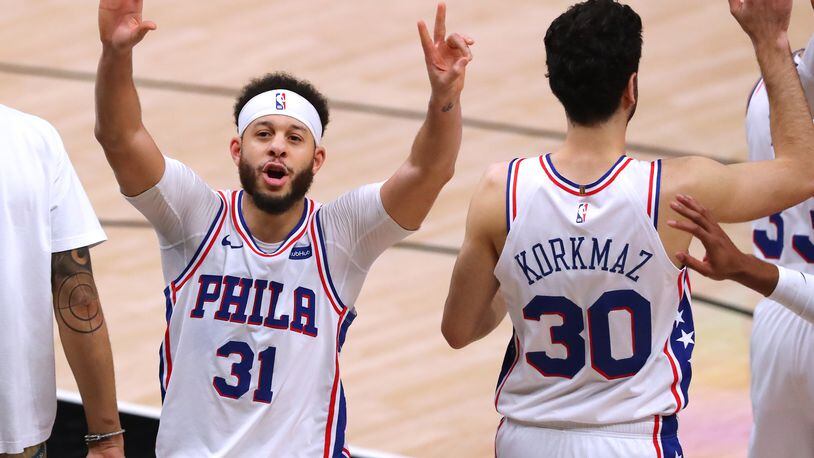 Philadelphia 76ers guard Seth Curry (left) lets the State Farm Arena crowd know there will be a Game 7 against the Hawks Sunday, at his place. “Curtis Compton / Curtis.Compton@ajc.com”