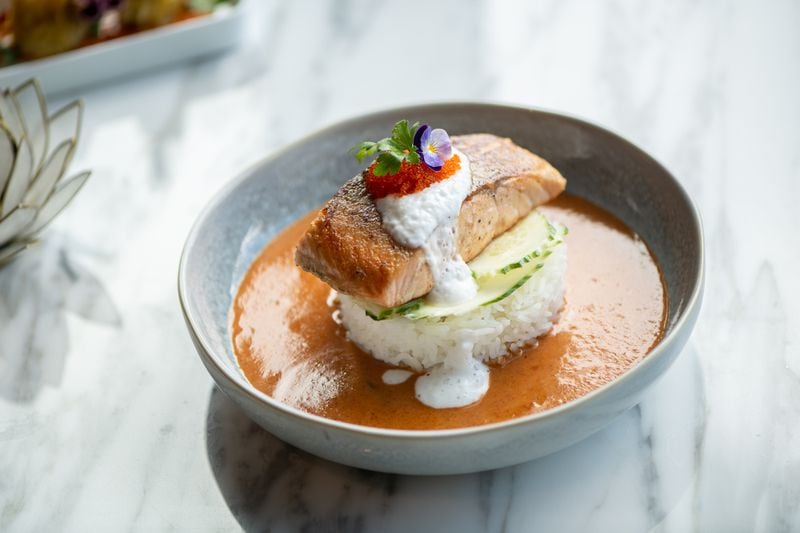 Yao's Salmon Panang with grilled Atlantic salmon, Panang curry, fresh cucumber, tobiko, coconut milk foam, and jasmine rice. (Mia Yakel for The Atlanta Journal-Constitution)