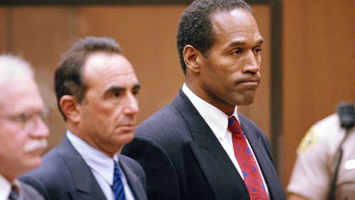 FILE - O.J. Simpson stands as he listens to Municipal Judge Kathleen Kennedy-Powell as she reads her decision to hold him over for trial on July 8, 1994, in connection with the June 12 slayings of his ex-wife Nicole Brown Simpson and Ronald Goldman. Simpson, the decorated football superstar and Hollywood actor who was acquitted of charges he killed his former wife and her friend but later found liable in a separate civil trial, has died. He was 76. (AP Photo/Eric Draper, Pool, File)