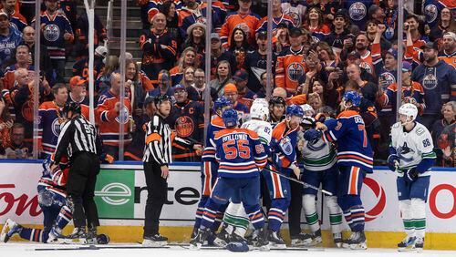 Vancouver Canucks and Edmonton Oilers rough it up during the third period of Game 6 of an NHL hockey Stanley Cup second-round playoff series, Saturday, May 18, 2024, in Edmonton, Alberta. (Jason Franson/The Canadian Press via AP)