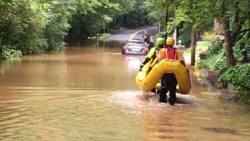 Atlanta fire officials rescued a man from the top of his car during flooding Wednesday. (Credit: Atlanta Fire Rescue)