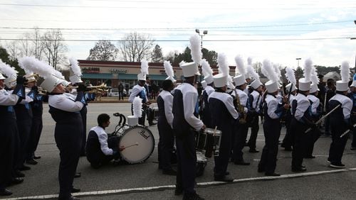 January 16, 2017, Atlanta - A bass drum player taps out and kneels for a short rest towards the conclusion to the annual MLK Day parade in Lawrenceville, Georgia, on Monday, January 16, 2017. (HENRY TAYLOR / HENRY.TAYLOR@AJC.COM)