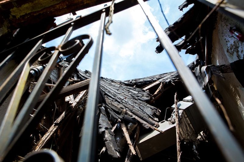The caved in roof is seen through a barred window at the childhood home of former Atlanta mayor Maynard Jackson at 220 Sunset Avenue NW in Atlanta, Ga., on Tuesday, May 7, 2019. The home, which has fallen into disrepair, is set to be demolished. (Casey Sykes for The Atlanta Journal-Constitution)