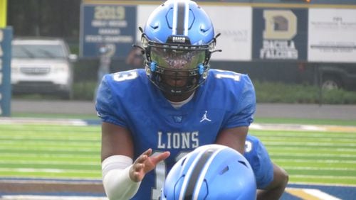 Westlake Lions quarterback R.J. Johnson takes a snap during their game against the Archer Tigers on Thursday, Aug. 19, 2021 in the Corky Kell Classic at Dacula's Barron Field. (Adam Krohn/special)