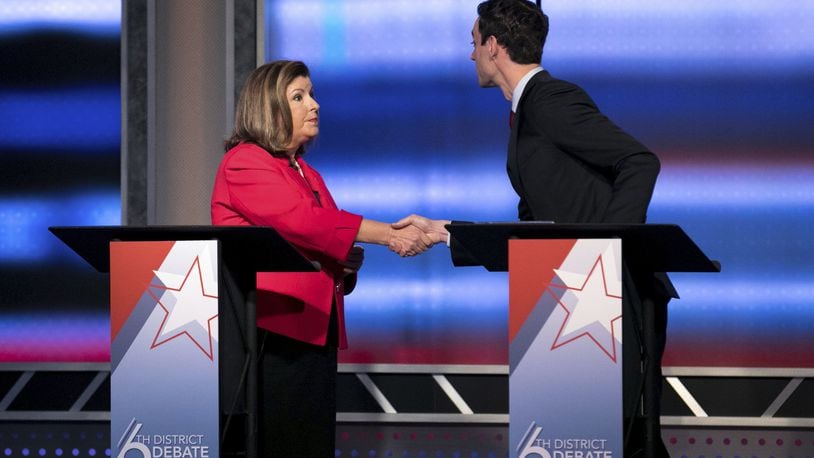 Candidates in Georgia’s 6th Congressional District race Republican Karen Handel, left, and Democrat Jon Ossoff shake hands after a debate Tuesday, June 6, 2017, in Atlanta. The two meet in a June 20 special election. (Branden Camp/Atlanta Journal-Constitution via AP)