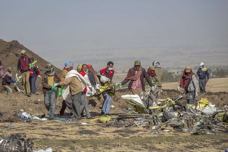 FILE - Rescuers work at the scene of an Ethiopian Airlines flight of a Boeing 737 Max 8 plane crash near Bishoftu, or Debre Zeit, south of Addis Ababa, Ethiopia, March 11, 2019. Boeing said Wednesday, April 24, 2024, that it lost $355 million on falling revenue in the first quarter, another sign of the crisis gripping the aircraft manufacturer as it faces increasing scrutiny over the safety of its planes and accusations of shoddy work. (AP Photo/Mulugeta Ayene, File)