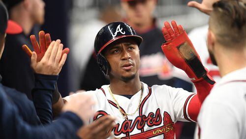 Ozzie Albies is congratulated after scoring in the third inning Thursday. His double in the inning was his majors-leading 15 extra-base hit, leaving him just two from matching the Atlanta record for extra-base hits through the end of April. (Photo by Scott Cunningham/Getty Images)