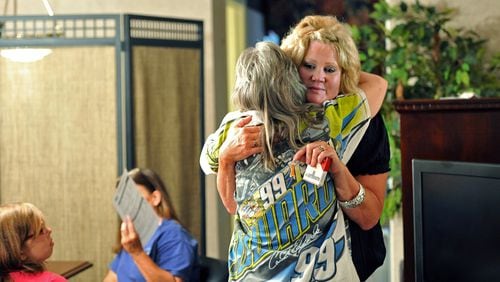 HICKS BABIES REUNITE--June 21, 2014 Ducktown, Tennessee - Melinda Elkins Dawson (right), of Canton, Ohio, who is one of Hicks Babies and organizer, gets a hug from Connie Sayers of Copperhill, Tennessee, who is a possible relative of Hicks baby, after Sayers had her DNA swab sampling done at Ocoee River Inn in Ducktown, Tennessee on Saturday, June 21, 2014. Melinda Elkins Dawson is one of about 200 babies who were sold from a clinic in McCaysville, GA in the 1950s and 1960s. Known as the Hicks Babies or the Hicks Adoptees, about 27 people, hoping to find their biological parents and get family medical histories, gathered Saturday in Ducktown, TN for DNA sample collection. Dawson worked with Ohio-based DNA Diagnostics Center to arrange free cheek-swab sampling Saturday at Ocoee River Inn in Ducktown, Tennessee, a few miles from where the clinic was located. HYOSUB SHIN / HSHIN@AJC.COM