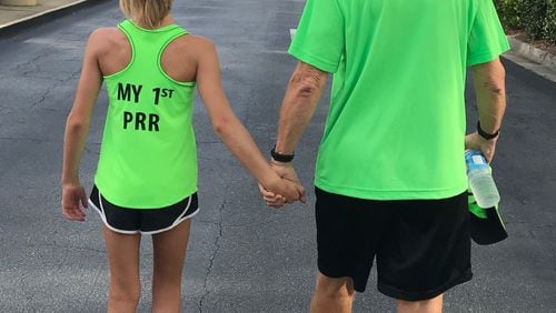 Barbara Lascody submitted this photo of “10-year-old Charlotte’s first Peachtree Road Race walking to the start line with her grandpa who has run in 43.”