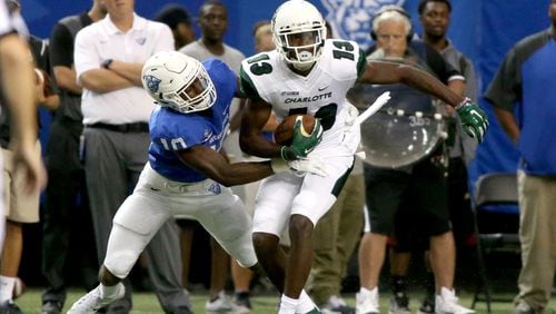 Georgia State Panthers cornerback Chandon Sullivan (10) tackles Charlotte 49ers wide receiver T.L. Ford (13) after a reception in the first quarter of their game at the Georgia Dome, September 4, 2015, in Atlanta. PHOTO / JASON GETZ