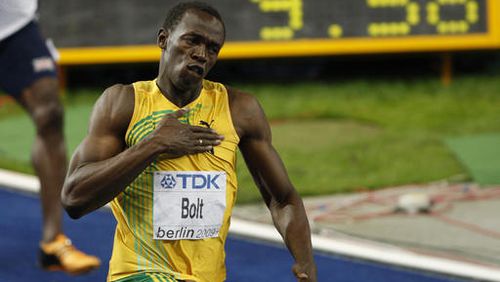 Jamaica's Usain Bolt celebrates setting a new men's 100m world record at the World Athletics Championships in Berlin on Aug. 16, 2009. (AP Photo/Michael Sohn, File)