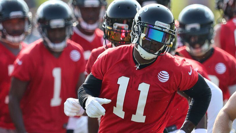 Falcons wide receiver Julio Jones runs a agility drill the first day of team practice at training camp on Thursday, July 27, 2017, in Flowery Branch.