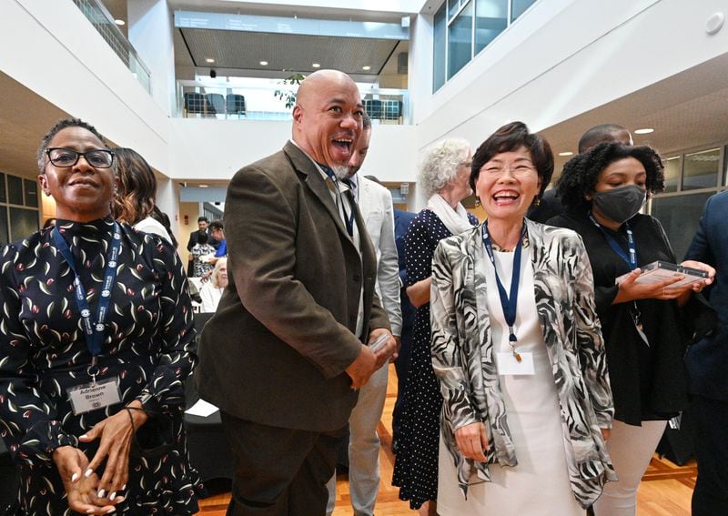 Myeong Hwa Jang, right, reacts during a group photograph with fellow graduates at the end of Gwinnett 101 Citizens Academy's Spring 2021 graduation ceremony. “Our local leaders have to know Asian Americans care for the county, the state, the country,” Jang says. (Hyosub Shin / Hyosub.Shin@ajc.com)