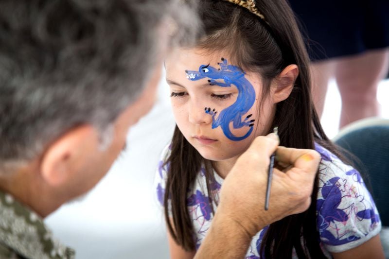 The AJC Decatur Book Festival offers a wide range of activities, including panel discussions, cooking demonstrations, and music. But it’s a festival, so Reuben Haller painting a dragon on Alexa Lee’s face during last year’s festival makes perfect sense. STEVE SCHAEFER / SPECIAL TO THE AJC