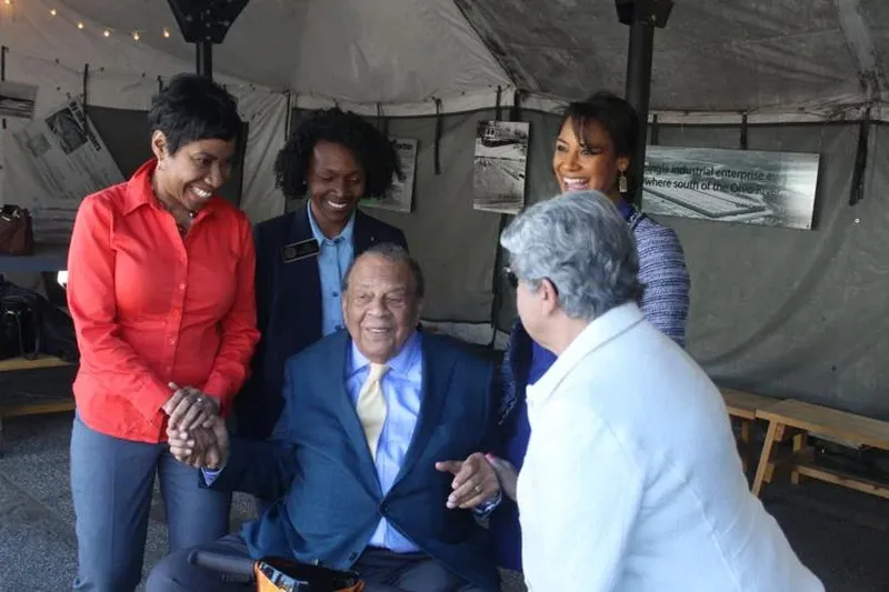 From left: Cobb Commissioners Monique Sheffield, Lisa Cupid, Jerica Richardson and JoAnn Birrell speak to former Ambassador and Atlanta Mayor Andrew Young. (Courtesy of Aleks Gilbert)