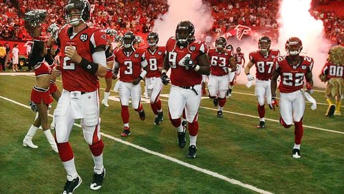 Matt Ryan leads the offense onto the field for his NFL debut Sunday, Sept. 7, 2008, at the Georgia Dome against the Detroit Lions. ( Curtis Compton/ AJC)