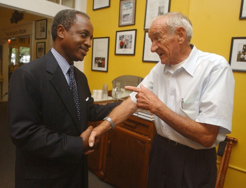 Michael Thurmond shakes hands with Ben Moon, a member of the Sons of Confederate Veterans, when Thurmond was state labor commissioner. (AJC file)