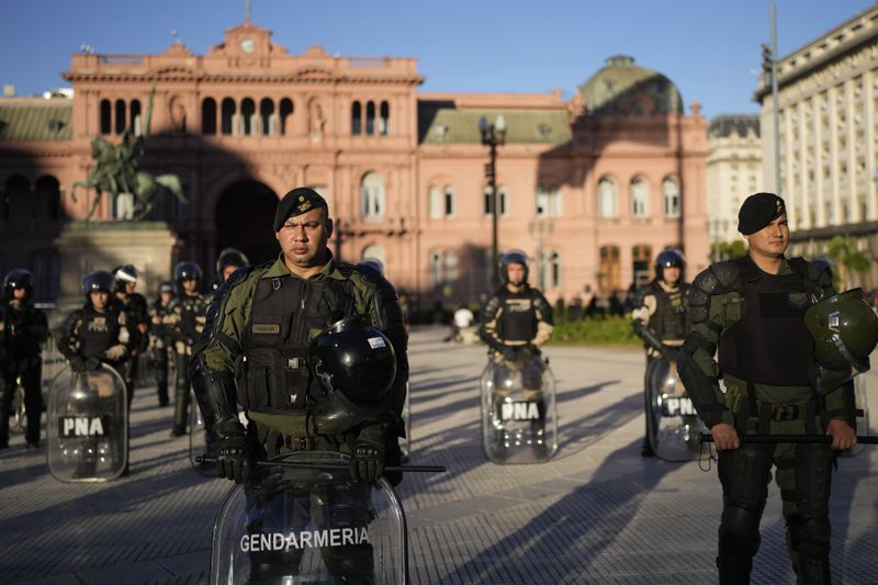Police guard the Casa Rosada presidential palace during a march demanding more funding for public universities and to protest against austerity measures proposed by President Javier Milei, in Buenos Aires, Argentina, Tuesday, April 23, 2024. (AP Photo/Natacha Pisarenko)